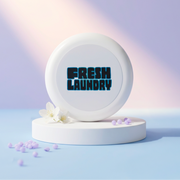 Round white container with 'Fresh Laundry' text on a light blue background