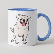 A white ceramic coffee mug with a blue handle and blue interior, featuring a cartoon illustration of a smiling white dog with a pink tongue on the front.