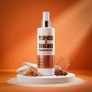 Fragrance mist bottle labeled 'Teakwood & Tanaline' on an orange background