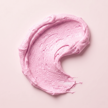 creamy pink dog face scrub product swatch on a light pink background
